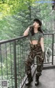 A woman in a military outfit standing on a balcony.