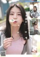 A young woman blowing a dandelion in front of her face.